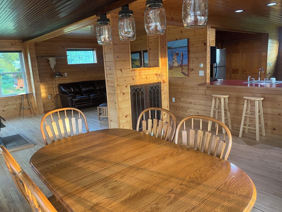 Large dining table seats 6 plus 2 at the kitchen counter.
