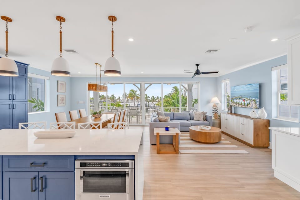 This spacious dining room features seating for the whole group, coastal-chic décor, and floor-to-ceiling views of the water for a true island dining experience.