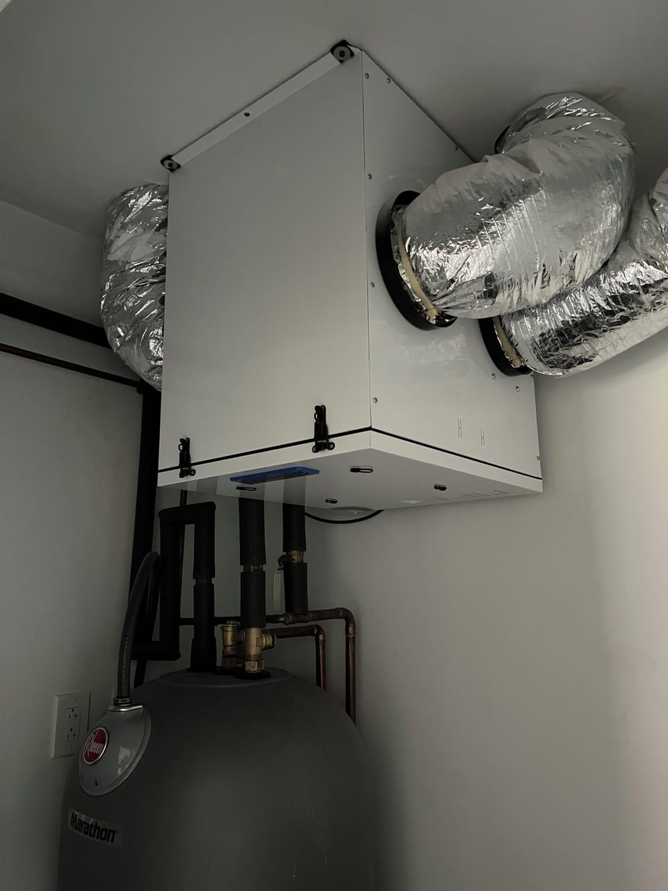 Renewaire energy recovery ventilation (ERV) above water heater.