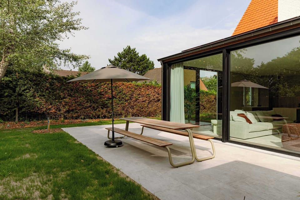 Sunny Garden Terrace with Dining Table and Parasol