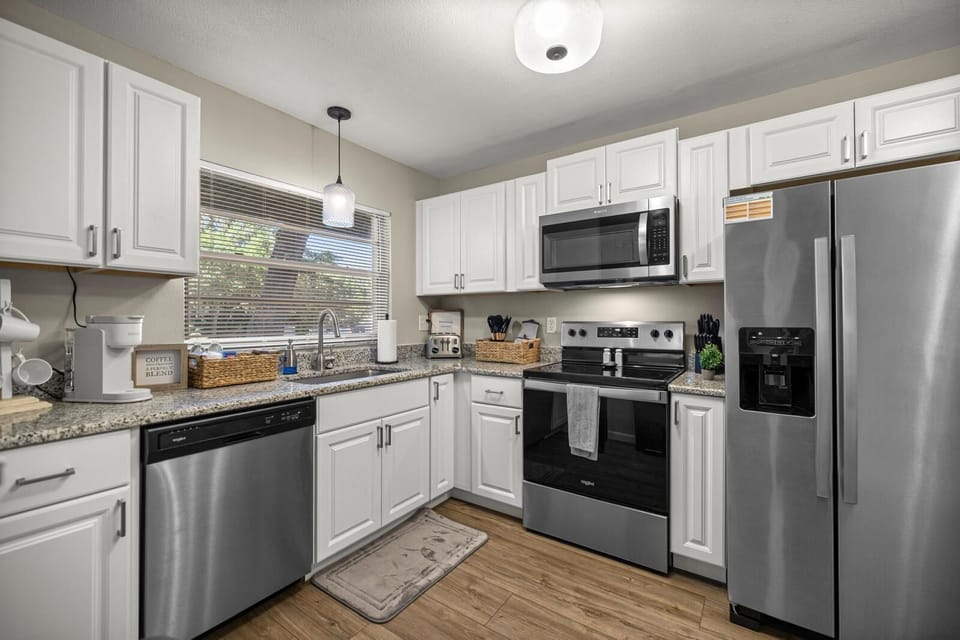 Fully equipped kitchen with sleek appliances, granite counters, and all the essentials for easy cook