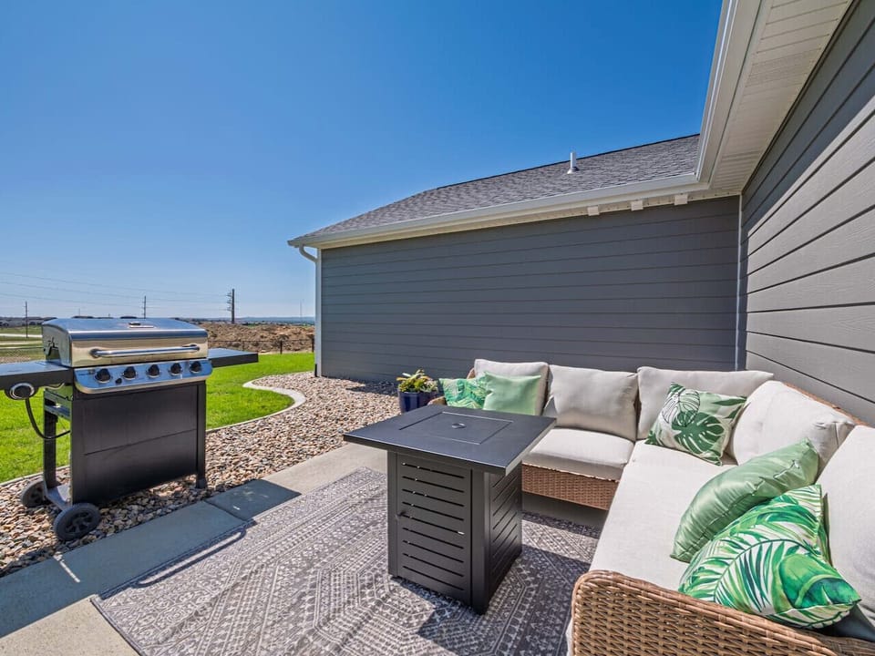 Enjoy the outdoors with cozy seating, a table fire pit for evening chats, and a gas grill ready for your BBQ favorites.