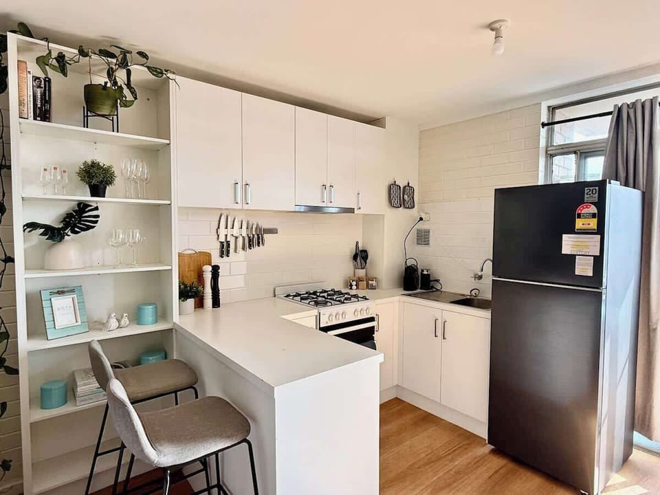Fully equipped with a gas stove, oven, and a spacious fridge for all your groceries. Enjoy casual mornings at the breakfast bar with comfy stools, surrounded by thoughtful decor and all the cooking essentials to make you feel right at home.