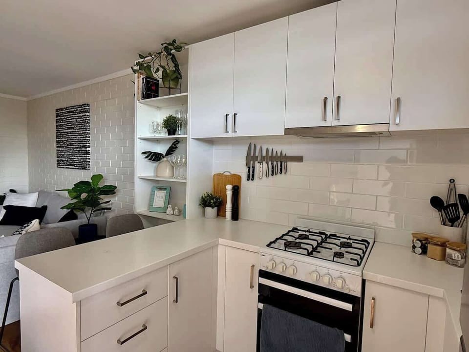 Whip up a delicious meal or simply enjoy a morning coffee! Our fully equipped, modern kitchen features everything you need, seamlessly connecting to a comfortable living area. 