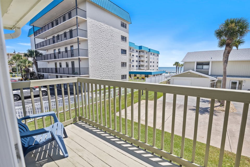 Enjoy your morning coffee with a peek of the ocean from this cozy balcony. Just steps from the beach, this relaxing retreat offers the perfect spot to unwind after a day of sun and surf.