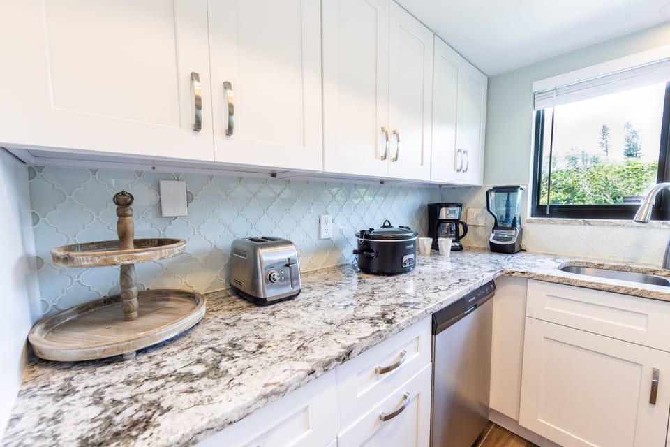 Enjoy cooking in this bright beachside kitchen featuring granite countertops, modern appliances, and all the essentials for your seaside getaway, from morning coffee to evening meals.