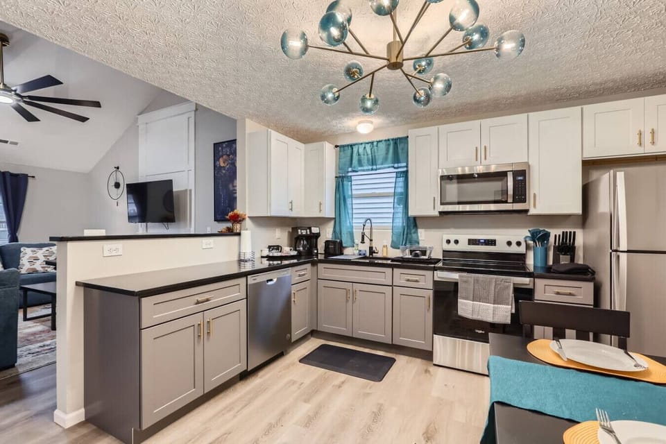 A fully equipped kitchen with modern appliances, quality utensils, spacious countertops, and a coffee setup for your convenience.