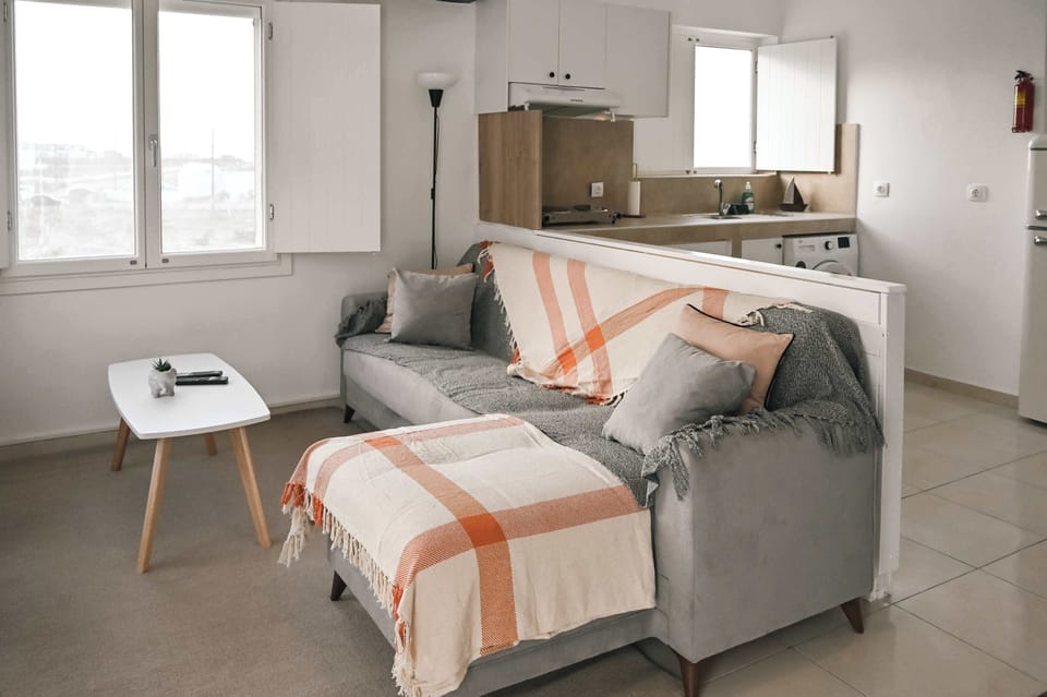 Bright and Comfortable Living Area
Cozy seating with a patterned throw and natural light, perfect for unwinding after a day exploring the island.

