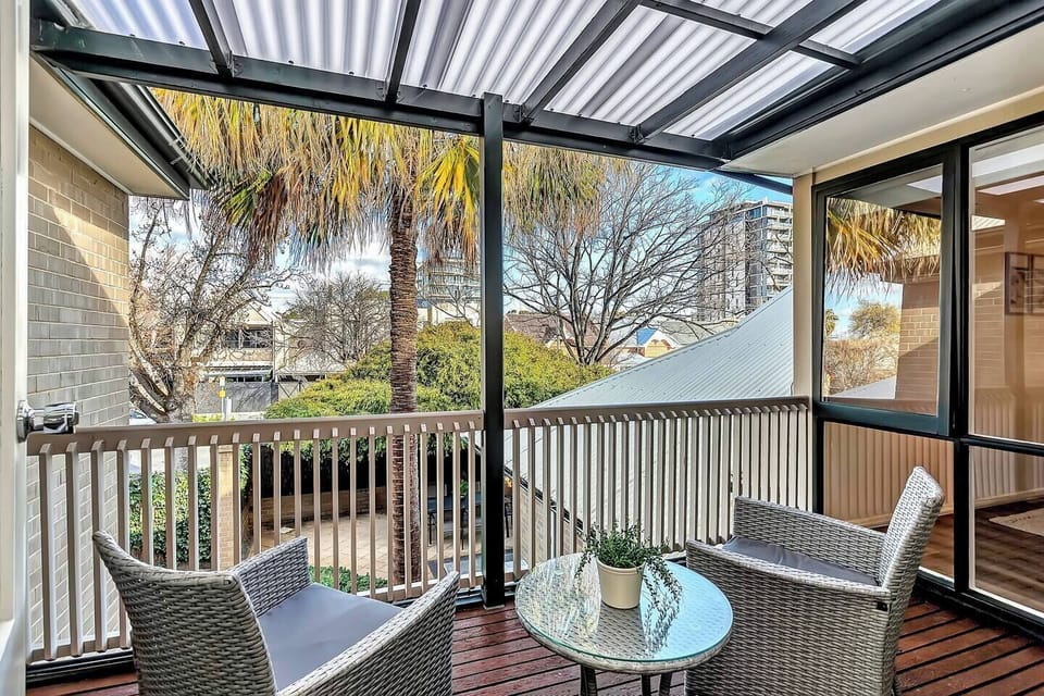 Enjoy fresh air and treetop views from your covered private balcony, accessible directly from the upstairs primary bedroom for a peaceful morning or sunset moment.