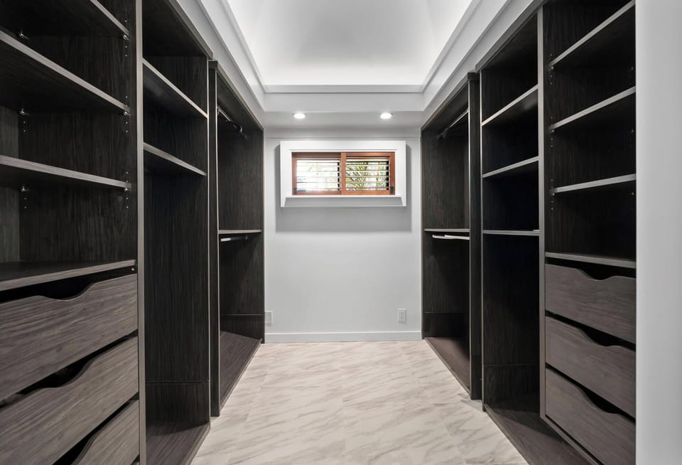 Stay organized in style—spacious walk-in closet with custom cabinetry for extended stays at Honolulu Lagoonfront Villa.