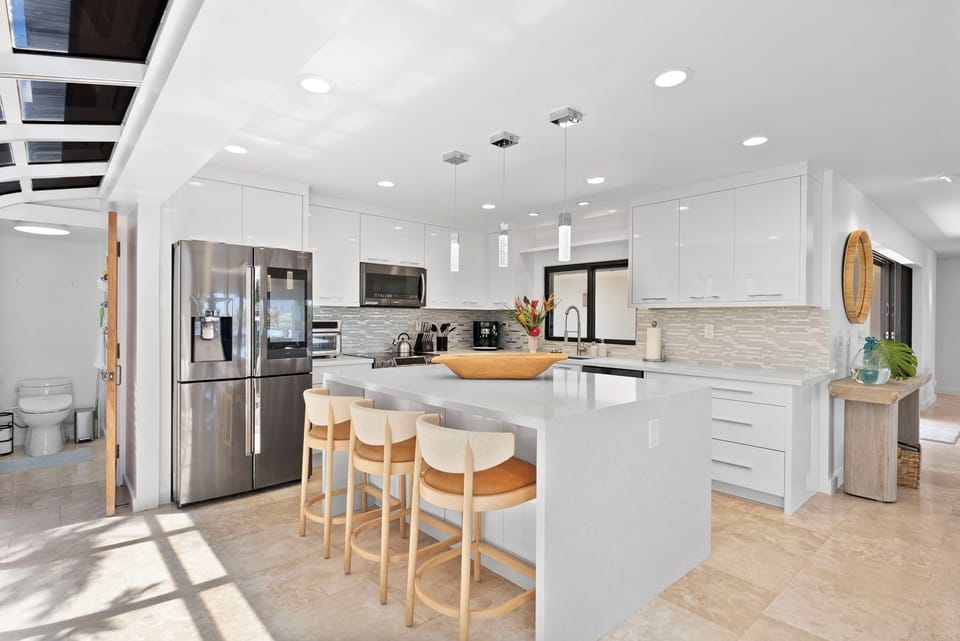 Whip up local favorites in the modern kitchen at Honolulu Lagoonfront Estate—complete with island seating and premium appliances.
