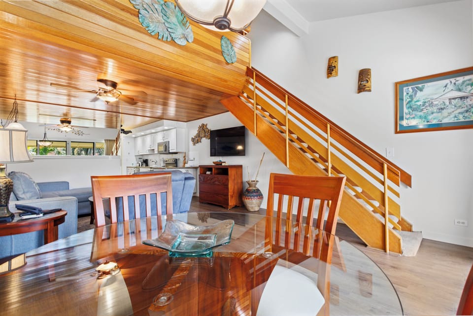 Warm wood tones and tropical touches create a welcoming open-concept space where you can gather, cook, and unwind—your island home away from home.