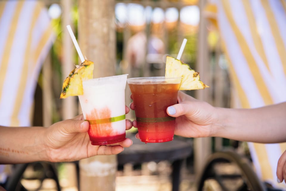 Cheers to vacation! These refreshing tropical drinks, garnished with pineapple wedges, set the tone for your relaxing poolside escape.