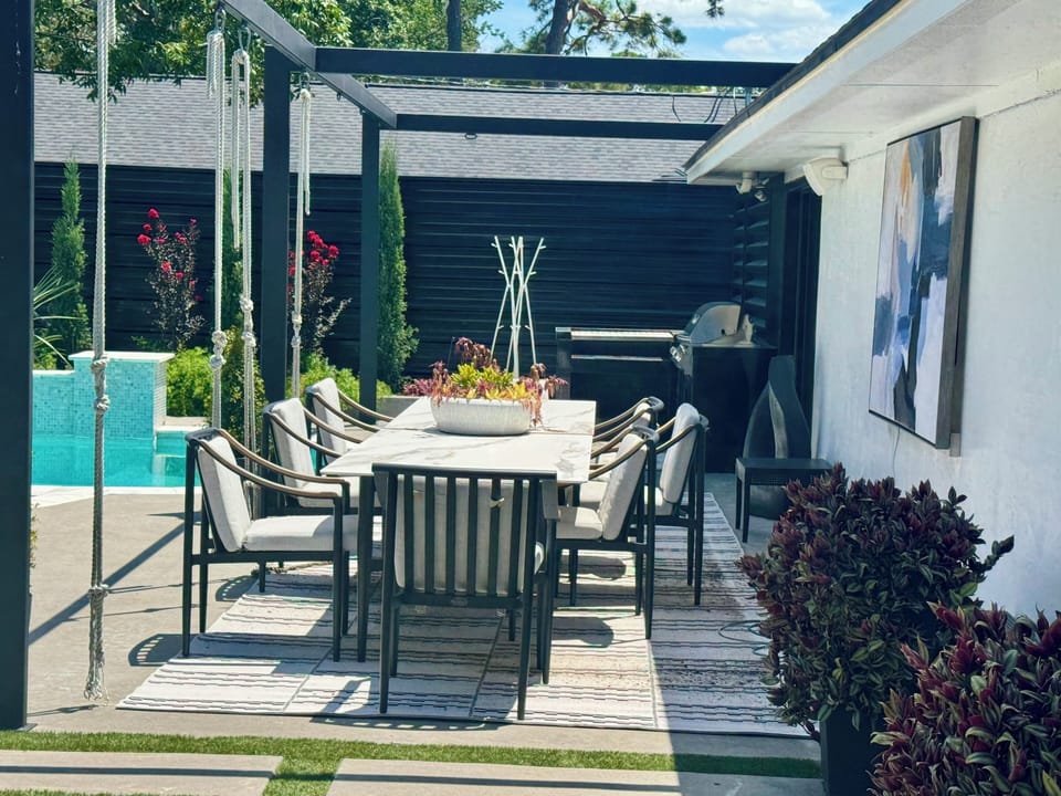 Outdoor dining area with seating for eight by the pool!