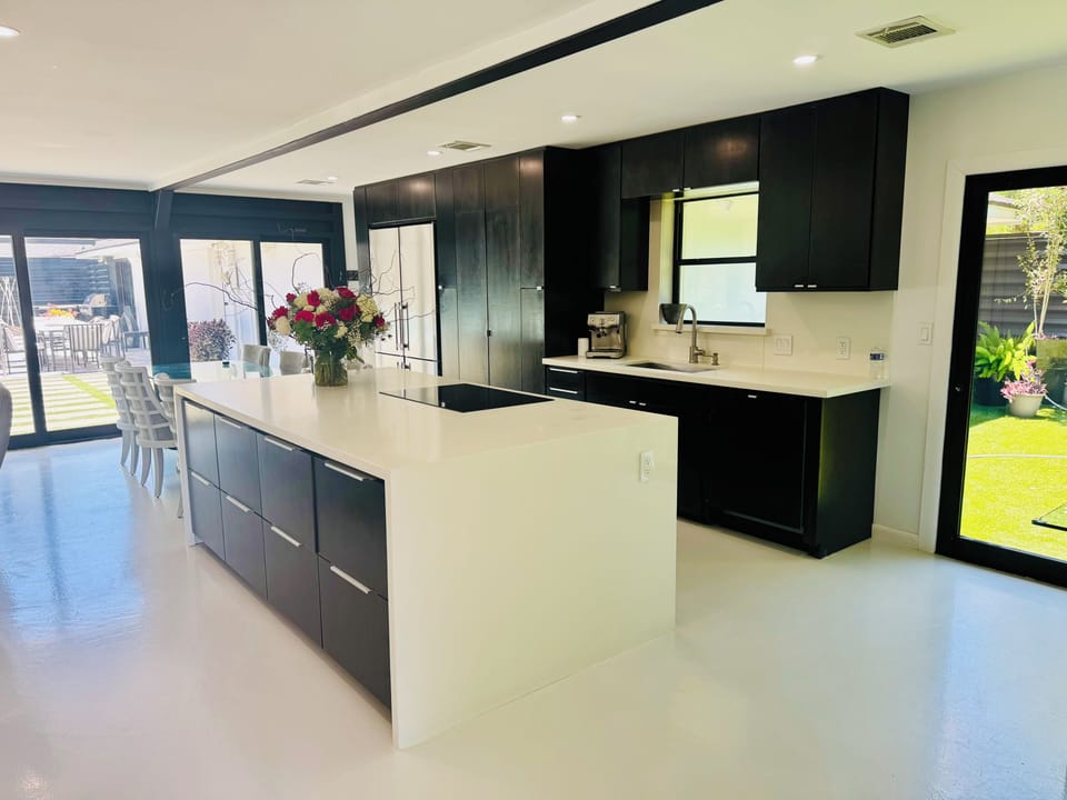 Updated, modern kitchen-open to living/dining areas and access to pool and patio