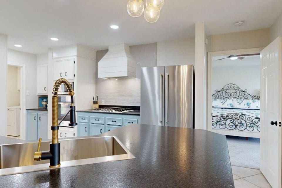 Beautifully updated kitchen with leathered granite countertops, stainless steal appliances, and completely stocked cookware, dinnerware, and serving dishes.
