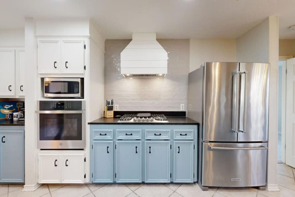 Beautifully updated kitchen with leathered granite countertops, stainless steal appliances, and completely stocked cookware, dinnerware, and serving dishes.