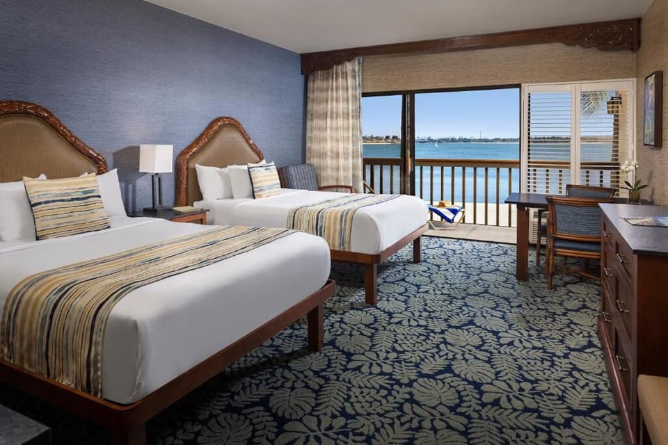 Unwind in crisp twin beds with sparkling bay views.