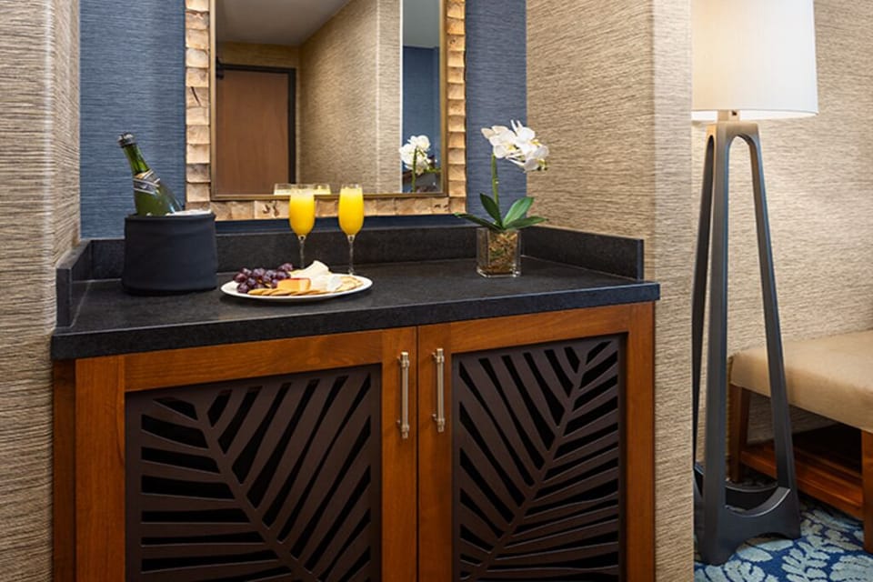 Savor chilled bubbly and snacks from the in-room refreshment bar.