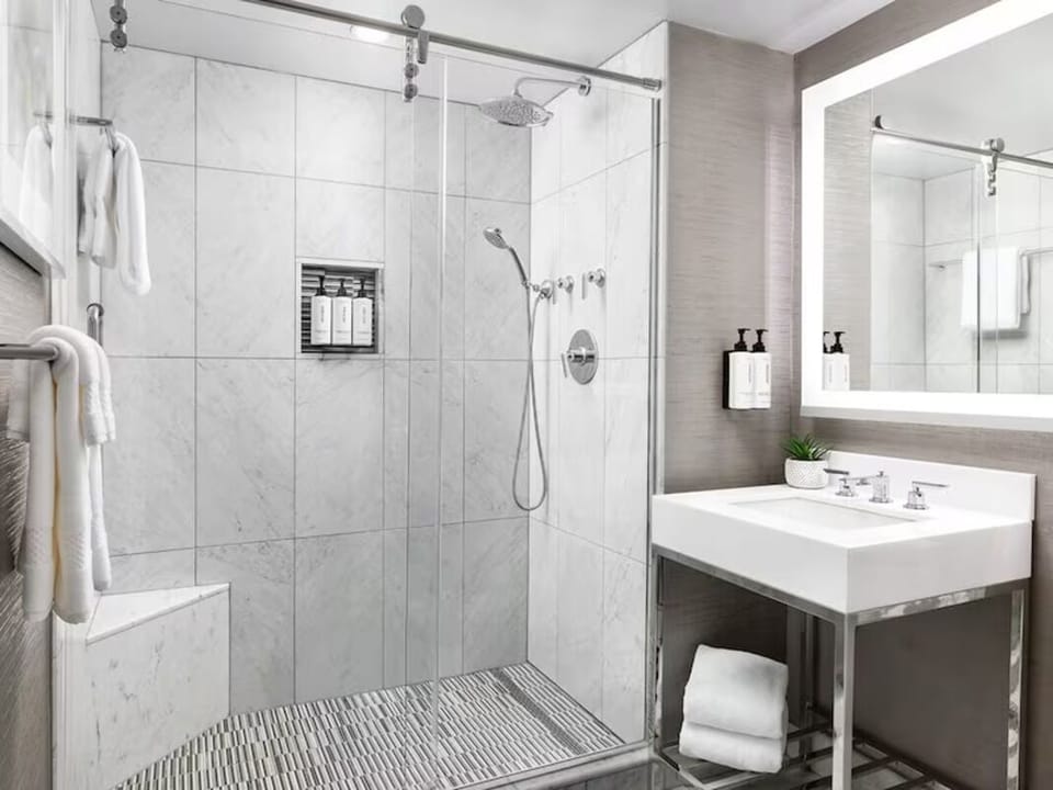 Refresh under the rainfall shower in a spotless, modern bath.