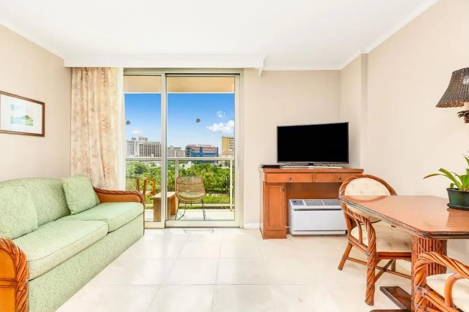 Unwind on the sofa with sunshine and balcony breezes.