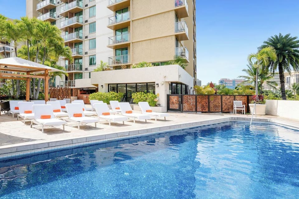 Sip something cool beside the pool at golden hour.