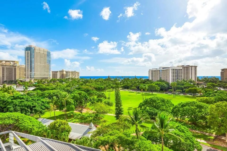 Wake up to sweeping tropical park views and blue ocean.