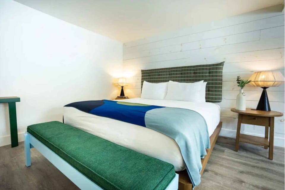 Drift off easily in a serene bed with warm lighting.