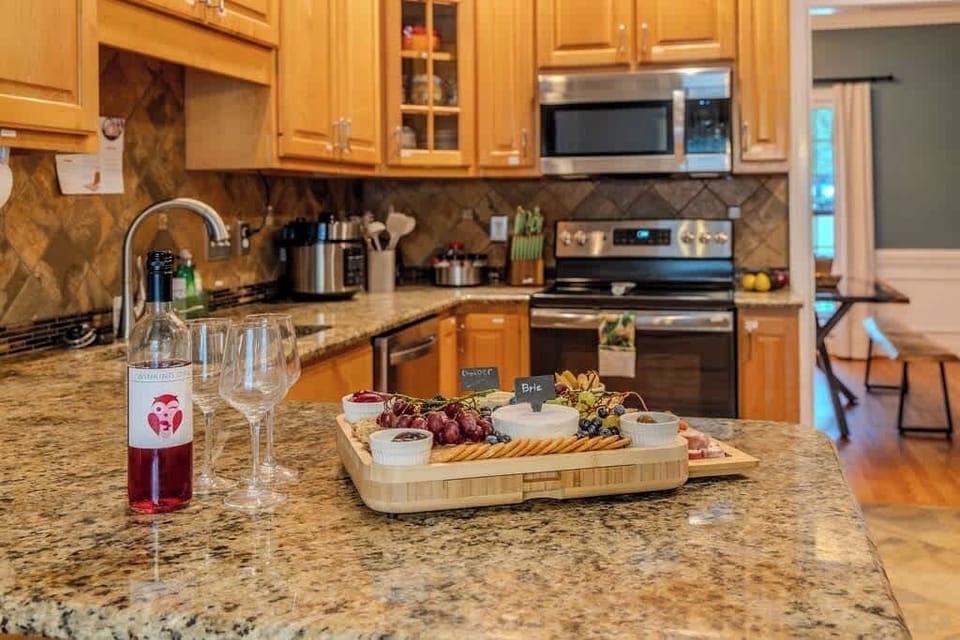 Enjoy this fully stocked kitchen that has three ovens. There is an additional full size fridge in the garage by the 10 foot bar as well. 