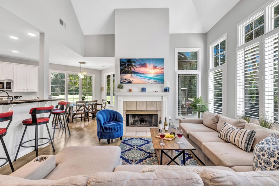 A sectional sofa, large flat-screen TV, and stylish decor make it the perfect spot to unwind after a day in the sun.