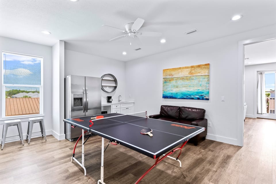 3rd Floor - Game room with ping-pong table, lounge seating, and kitchenette with a full fridge/freezer, ice maker, and a sink