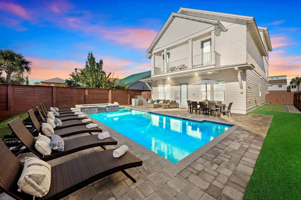 Coastal Charmer – sleeps 22 and just steps from the beach! Includes FREE golf cart, HEATED pool, hot tub, fire pit, outdoor kitchen, and 2 game rooms with pool table, ping-pong, and foosball. Perfect for families and groups seeking fun and relaxation!