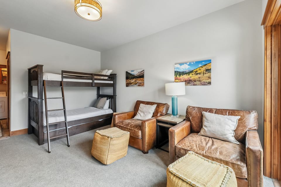 Lounge area: Twin-over-twin bunk bed, lower floor, washer/dryer access nearby, two armchairs with ottomans, closet, access to hot tub
