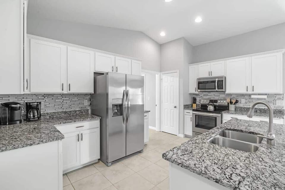 Fully equipped and stocked kitchen with all major appliances, kitchen table with 4 chairs and island with 4 stools.