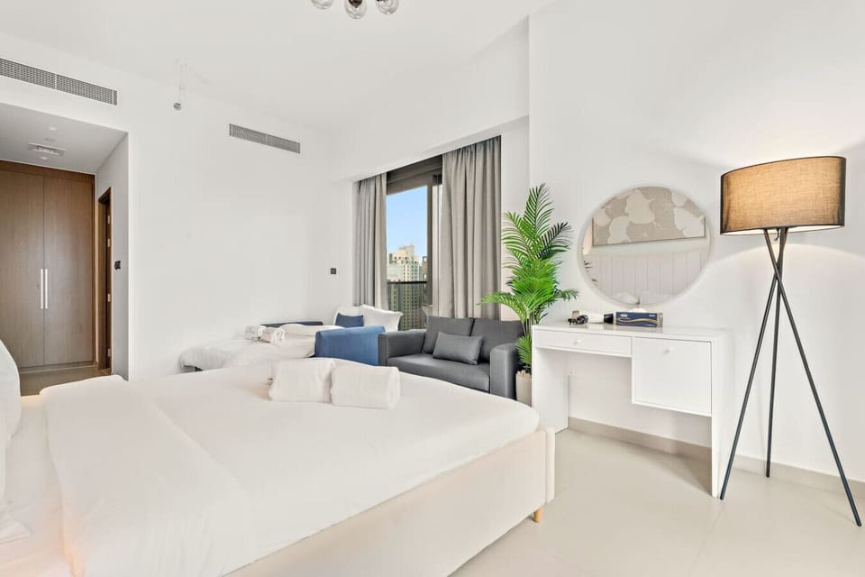 Bright Retreat: Enjoy stunning city views and stylish decor in this inviting bedroom !