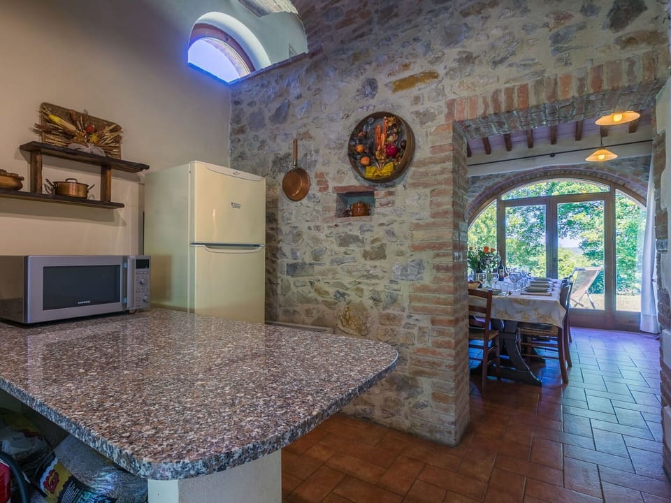 Flooring, Furniture, Ceiling, Kitchen & Dining Room Table, Countertop, Chair, Brick, Stone Wall, Houseplant, Kitchen