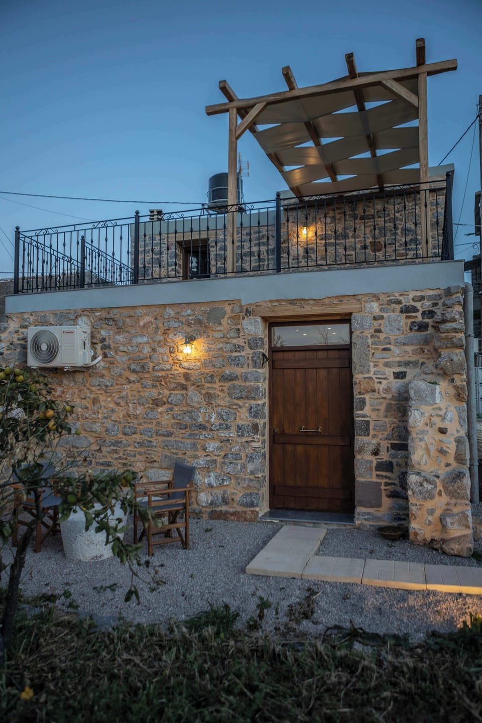 Stone House Exterior View with Courtyard – Daytime