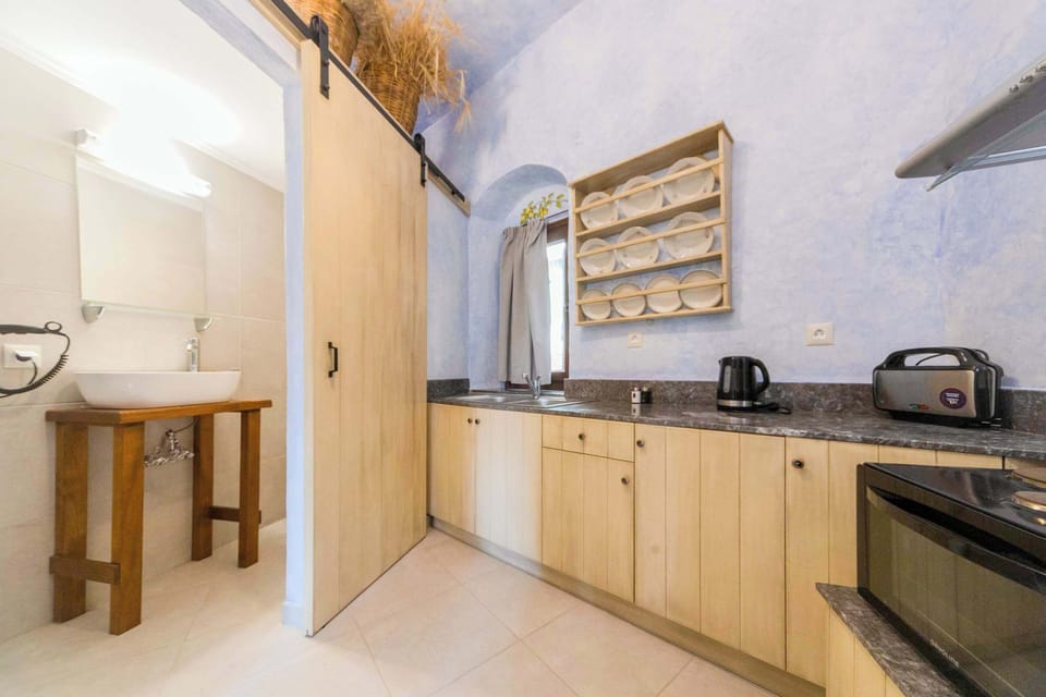 Kitchenette with Wooden Cabinets and Essential Appliances for Home Cooking