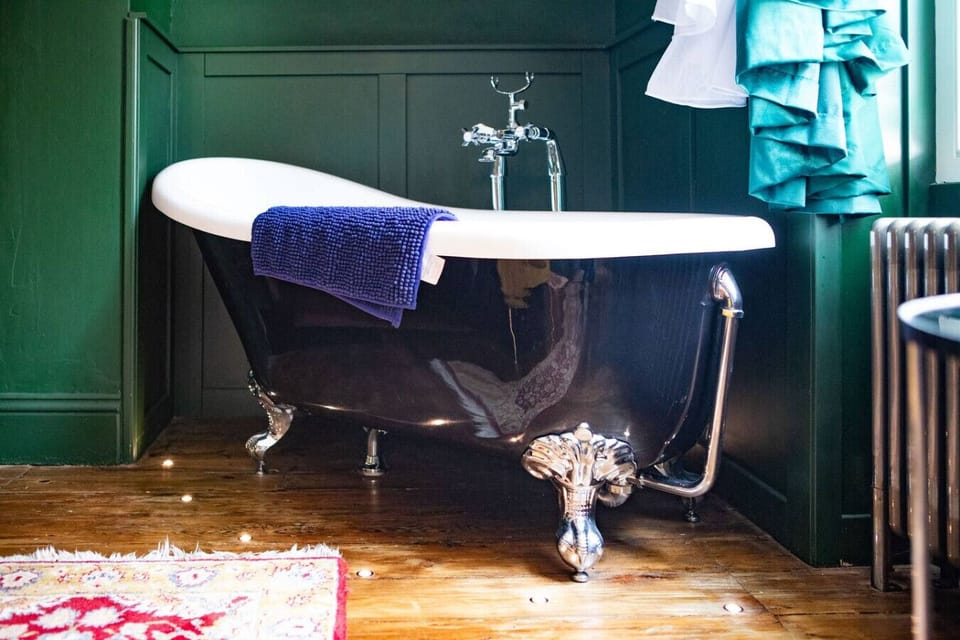 Elegant clawfoot bath for indulgent soaks.