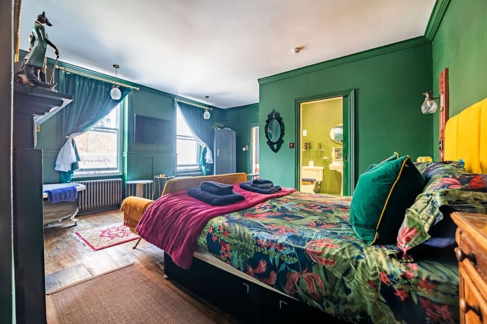 View across the bed toward window and seating.