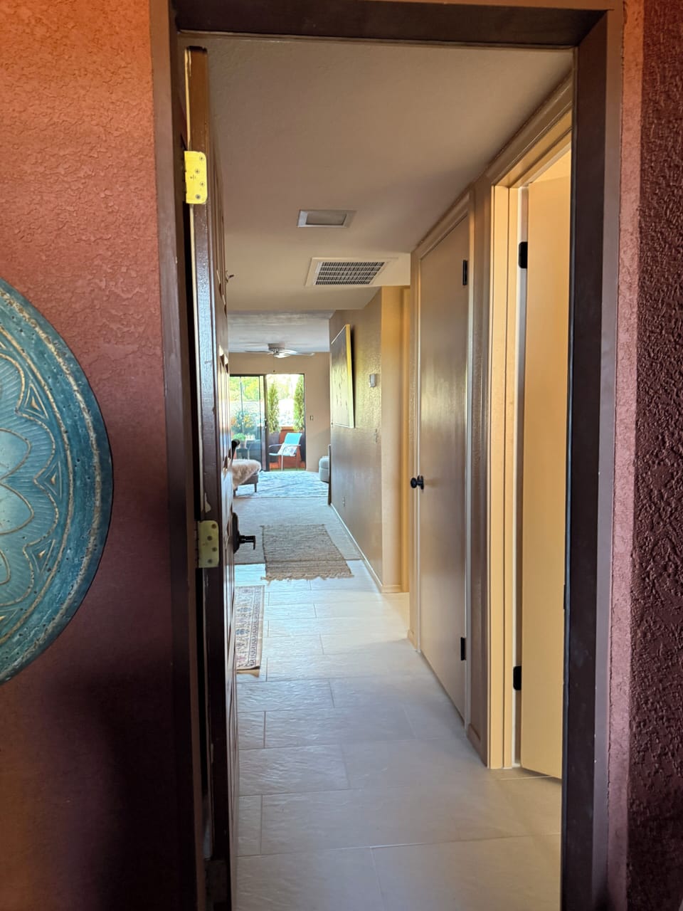 Walking in the back door of condo from covered, prvate garage