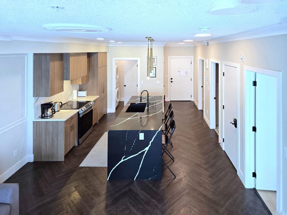 Open-concept Calgary condo kitchen and dining area, modern design