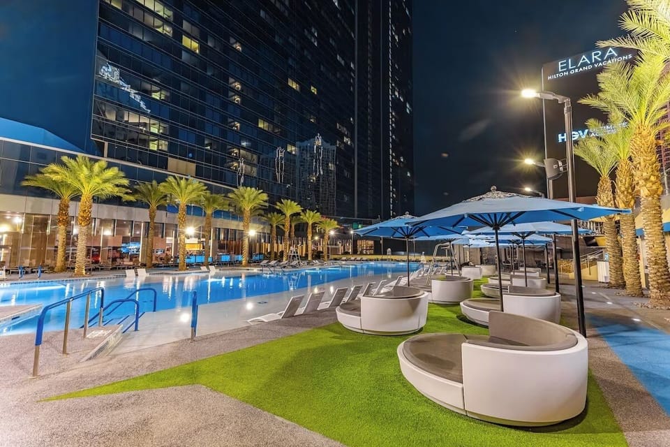 Seasonal outdoor pool with cabanas & sun loungers & pool umbrellas