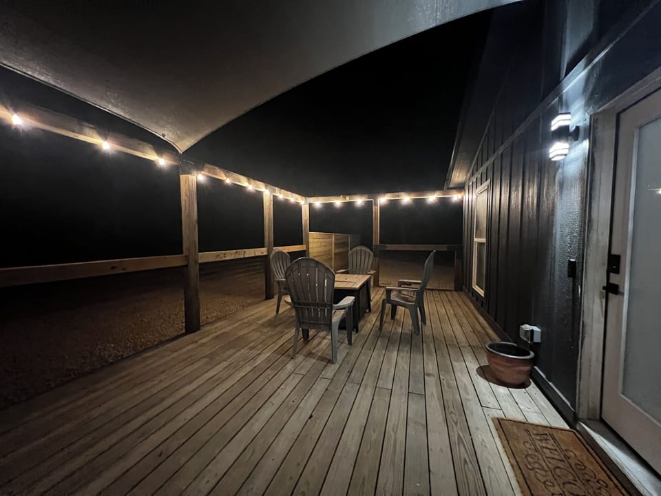 Extra large porch with privacy screens, fire table and seats for cold nights