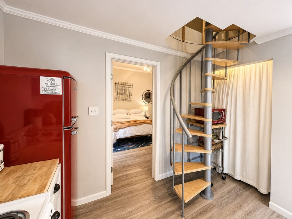 Ascend the spiral staircase to your King bedroom & loft