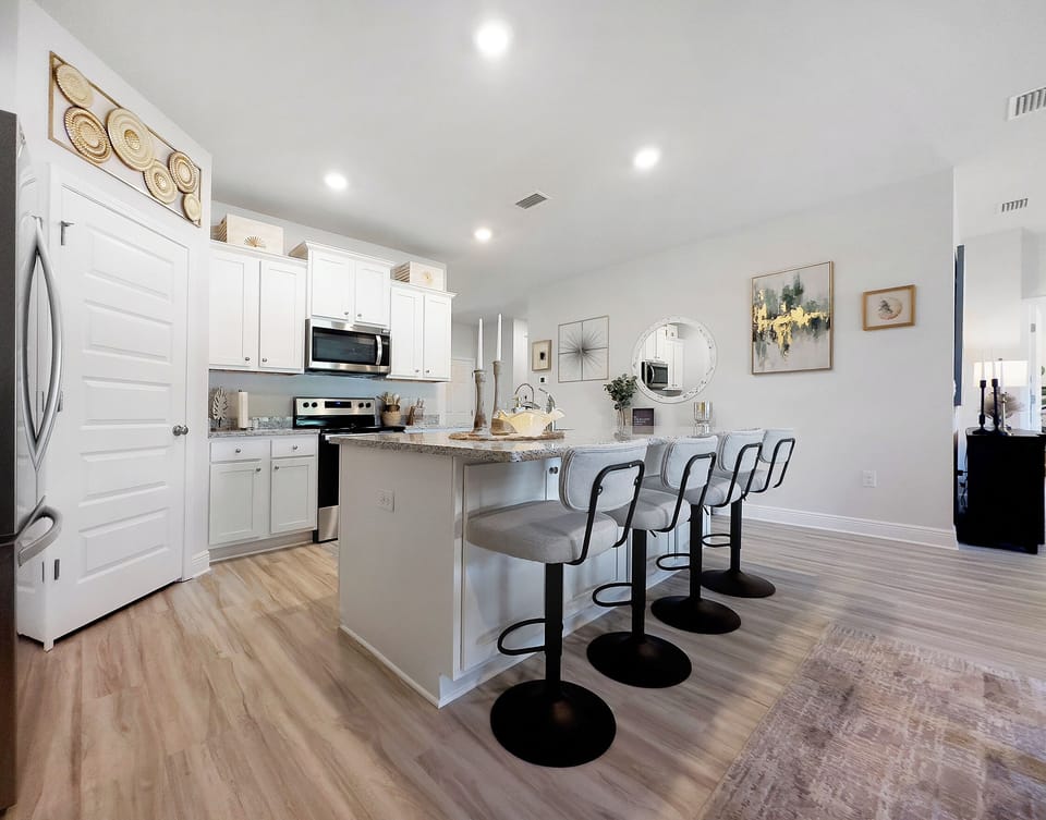 Full equipped kitchen with island and dining table seating.