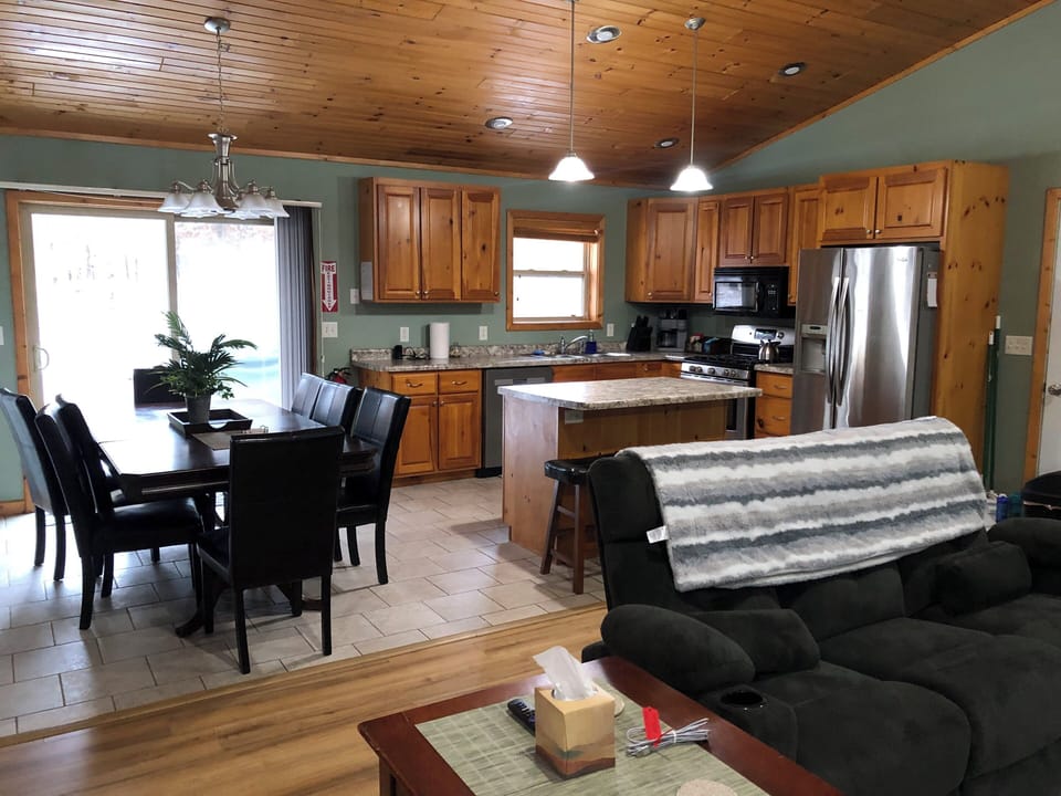 Open kitchen with new appliances, dishwasher, electric stove and seating for 8