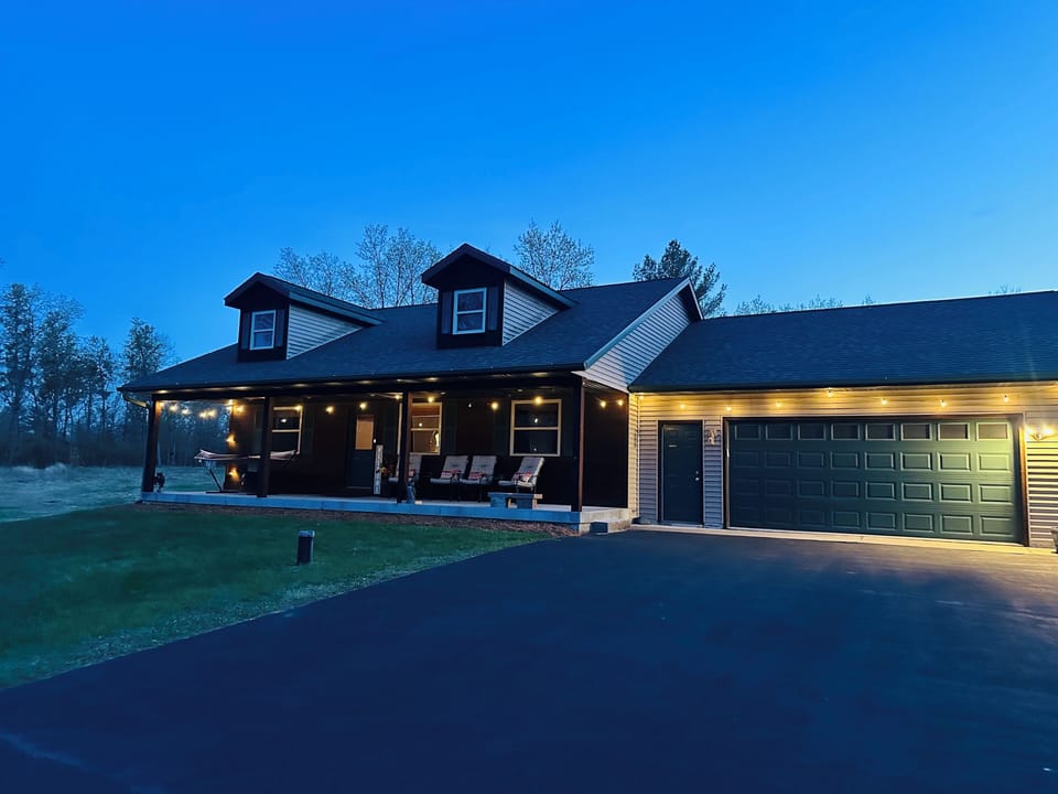Relax on the large covered porch with many cushioned chairs and a double hammock