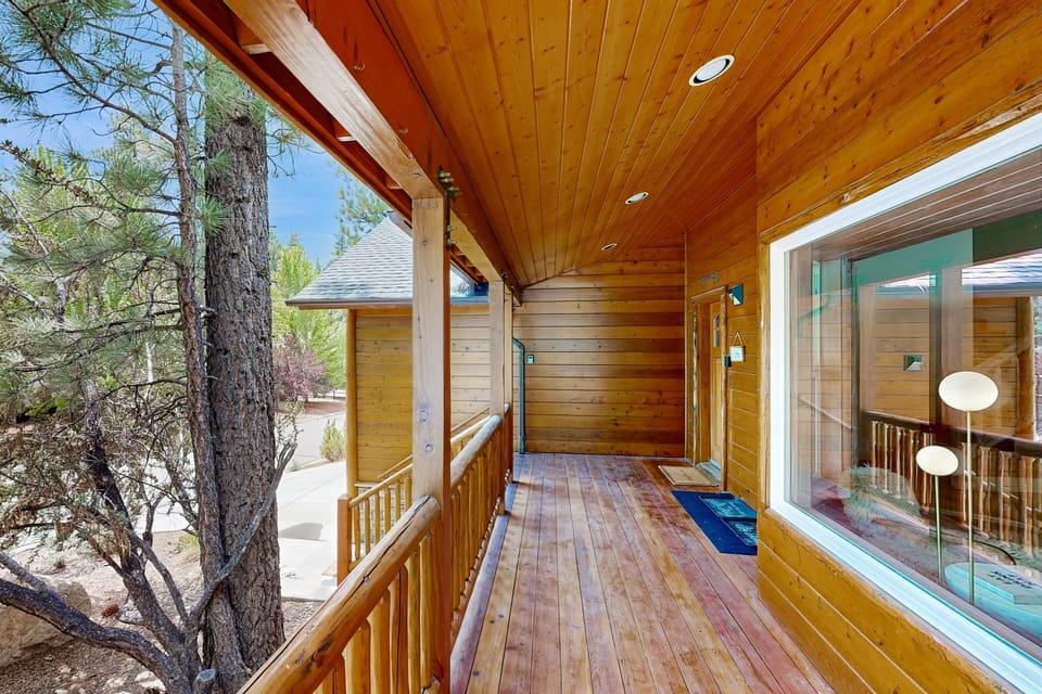 Welcoming cabin entry surrounded by towering pine trees, offering fresh mountain air and a peaceful forest setting—the perfect first impression for your Big Bear Lake getaway.