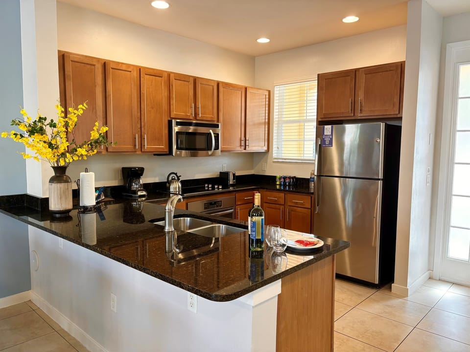 Open kitchen with stainless steel appliances and granite countertops